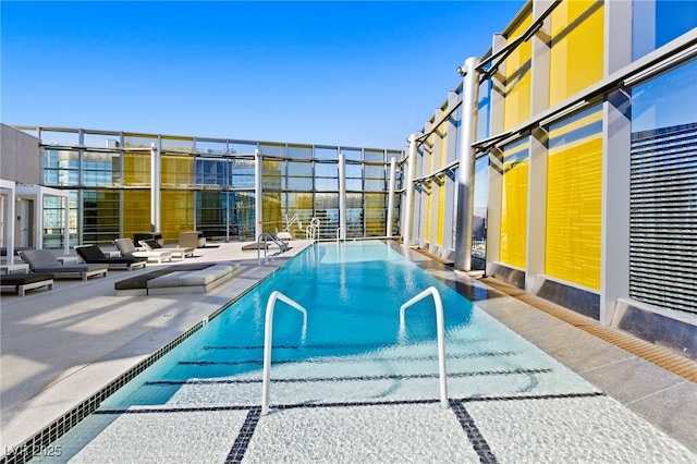 community pool with a patio area