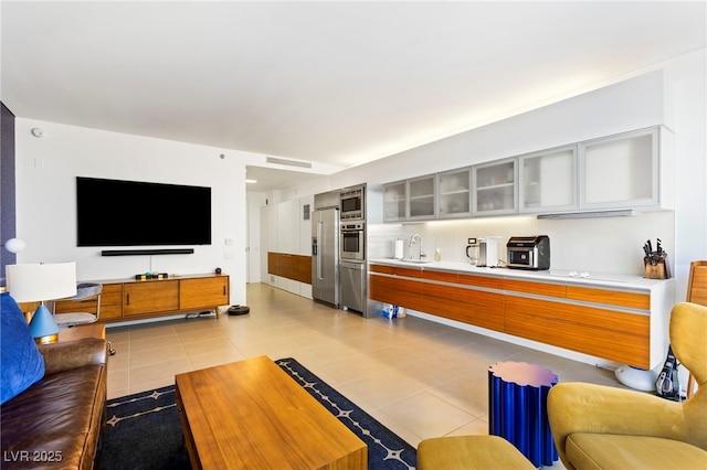 living area with light tile patterned flooring and visible vents