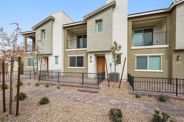 multi unit property featuring fence and stucco siding