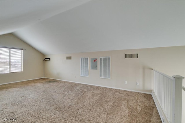 bonus room with carpet, visible vents, and vaulted ceiling