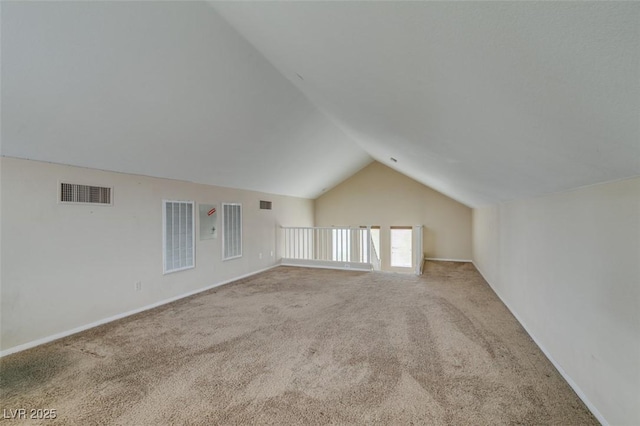 additional living space featuring lofted ceiling, visible vents, and carpet