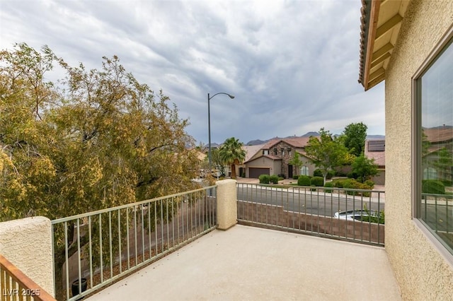 view of patio / terrace featuring a balcony and a residential view