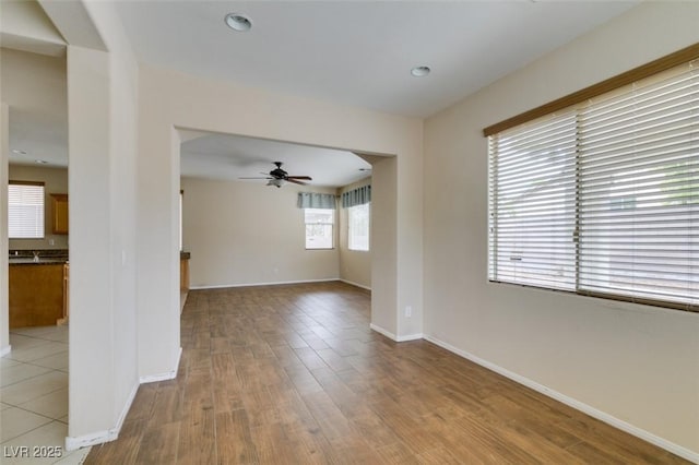 unfurnished room featuring a ceiling fan, recessed lighting, baseboards, and wood finished floors