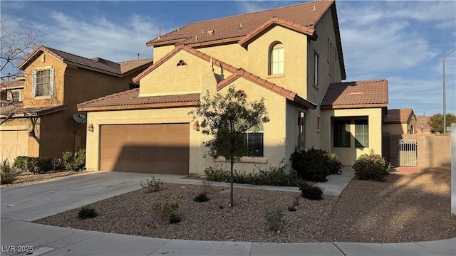 mediterranean / spanish-style house with stucco siding, concrete driveway, and a tiled roof