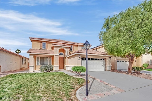 mediterranean / spanish-style home with a garage, concrete driveway, stucco siding, a tiled roof, and a front yard