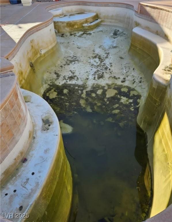 view of swimming pool featuring an in ground hot tub