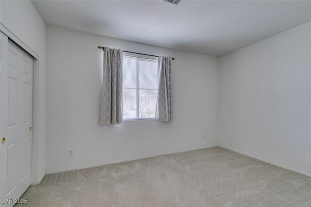 empty room featuring light carpet