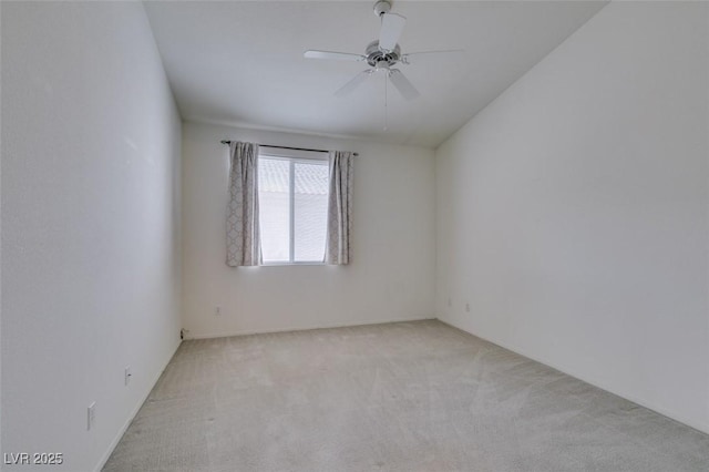 empty room featuring ceiling fan and light colored carpet