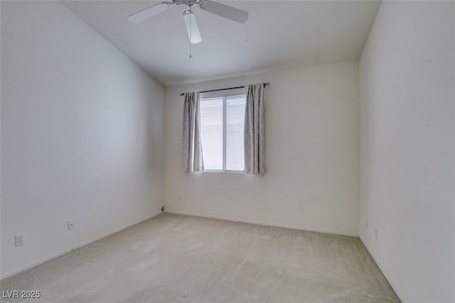 unfurnished room featuring ceiling fan and light colored carpet