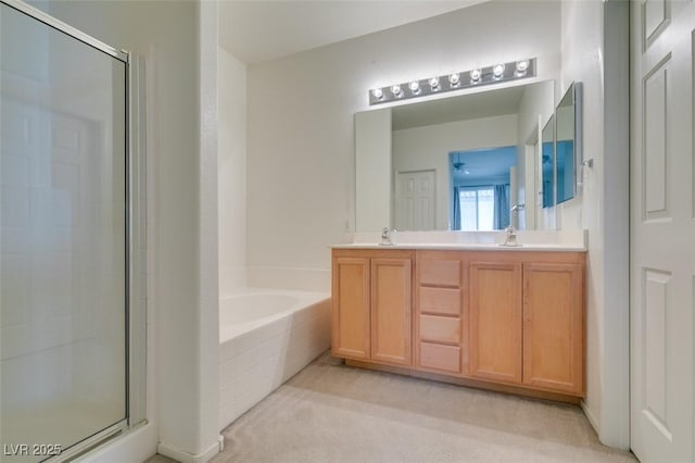 full bath with a garden tub, double vanity, a sink, and a shower stall