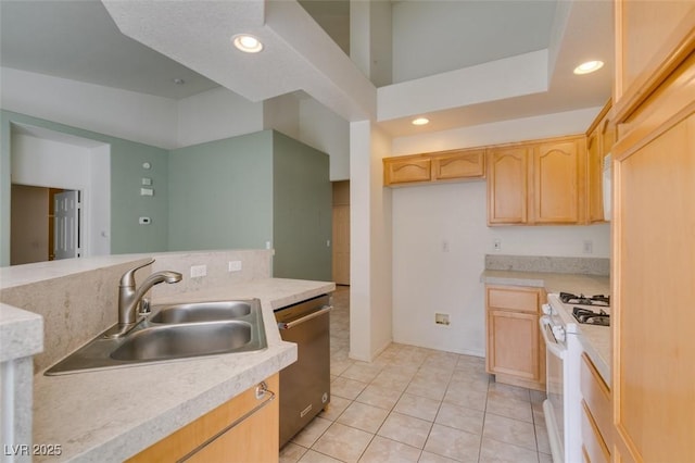 kitchen with white range with gas cooktop, light countertops, stainless steel dishwasher, light brown cabinets, and a sink