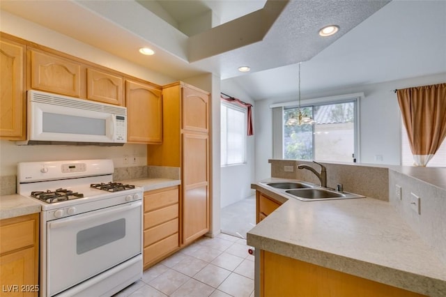 kitchen with recessed lighting, white appliances, a sink, and light brown cabinetry