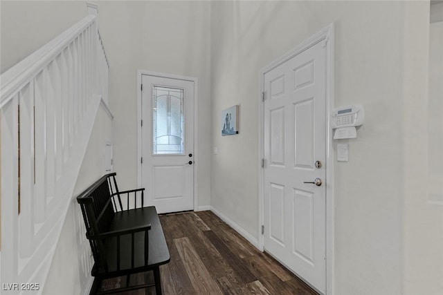 foyer with baseboards and dark wood finished floors