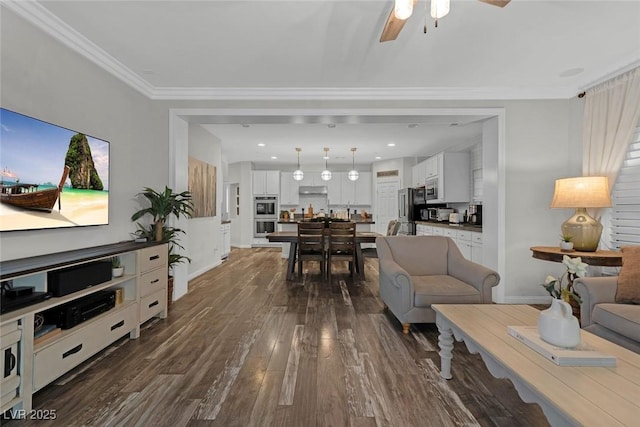 living room with crown molding, dark wood finished floors, baseboards, and ceiling fan