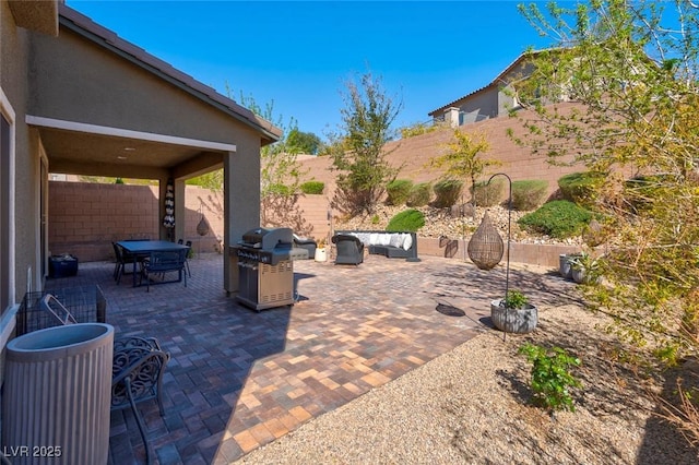 view of patio featuring a fenced backyard, outdoor lounge area, and a grill