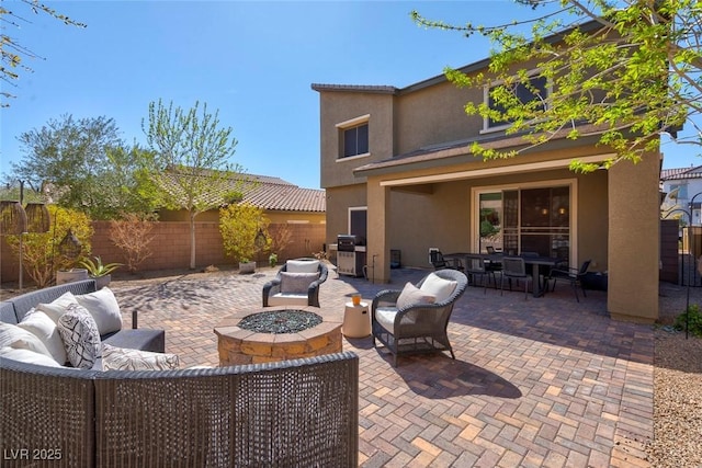 view of patio / terrace with outdoor dining area, a fenced backyard, and an outdoor living space with a fire pit