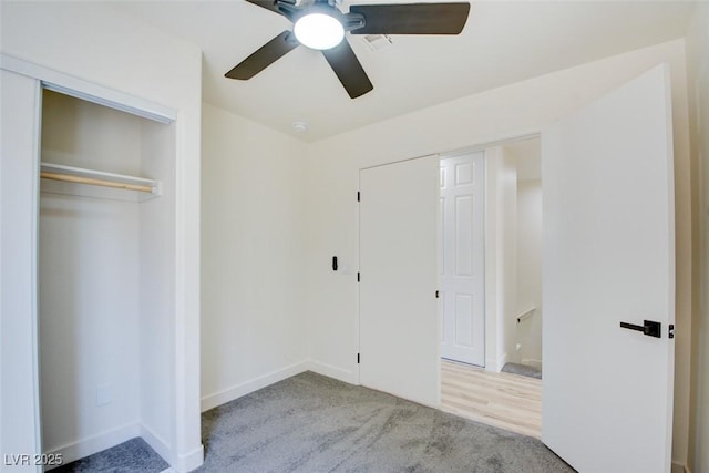 unfurnished bedroom featuring carpet floors, baseboards, and a ceiling fan