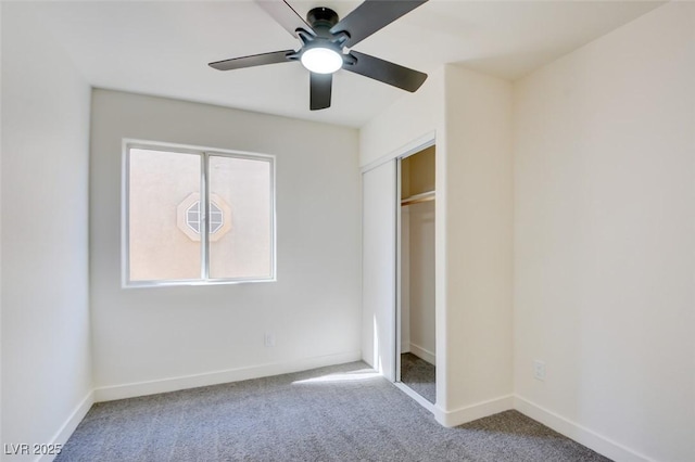 unfurnished bedroom featuring carpet, a closet, ceiling fan, and baseboards