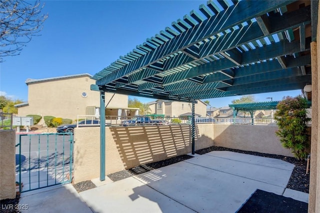 view of patio with fence, a residential view, and a pergola