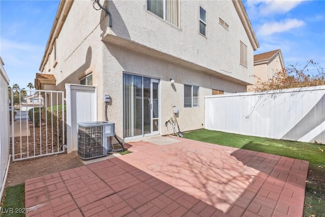 view of patio / terrace with central air condition unit and fence