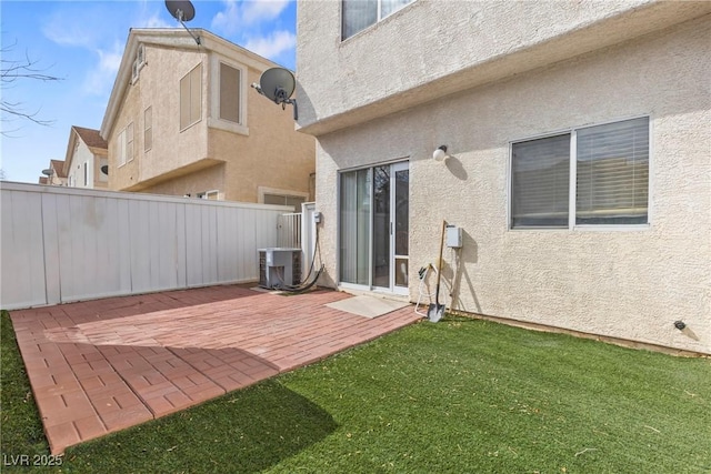 back of house with a patio, stucco siding, a lawn, central AC unit, and fence