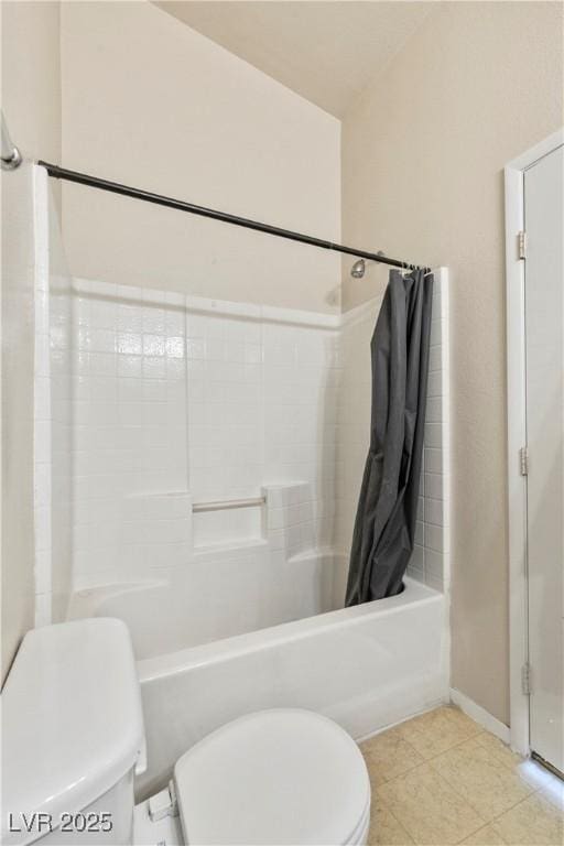 bathroom featuring tile patterned flooring, shower / bath combo with shower curtain, toilet, and baseboards