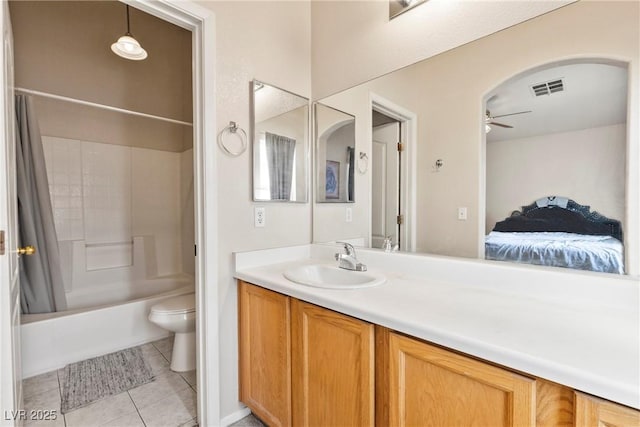 bathroom featuring tile patterned flooring, toilet, vanity, visible vents, and a ceiling fan