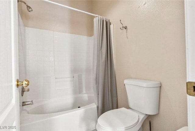 full bath with shower / bath combo with shower curtain and toilet