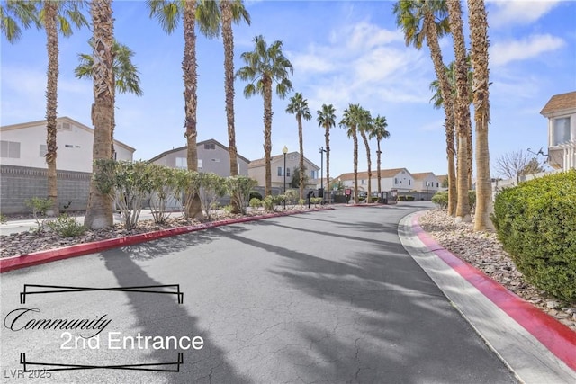 view of road with a residential view and curbs