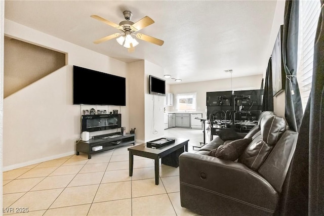 living area with visible vents, ceiling fan, baseboards, and light tile patterned floors