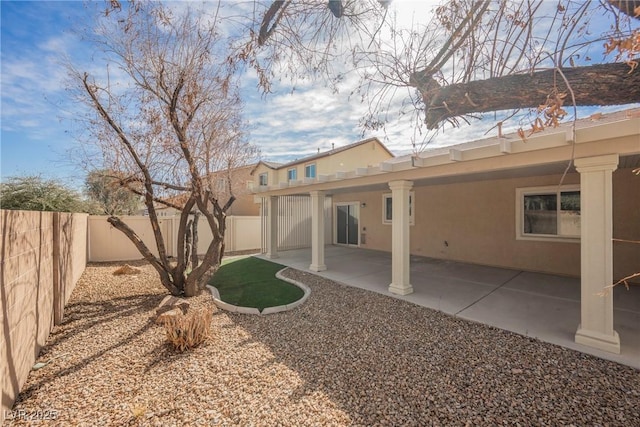 back of house featuring a patio area, a fenced backyard, and stucco siding