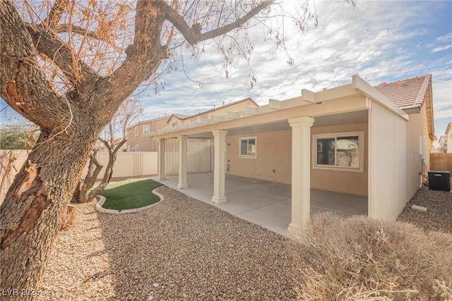 back of house featuring a patio, a fenced backyard, cooling unit, a tile roof, and stucco siding