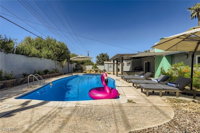 view of swimming pool featuring a patio area, a fenced backyard, and a fenced in pool