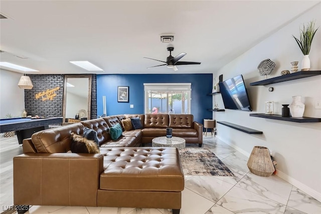 living area with a ceiling fan, marble finish floor, visible vents, and baseboards