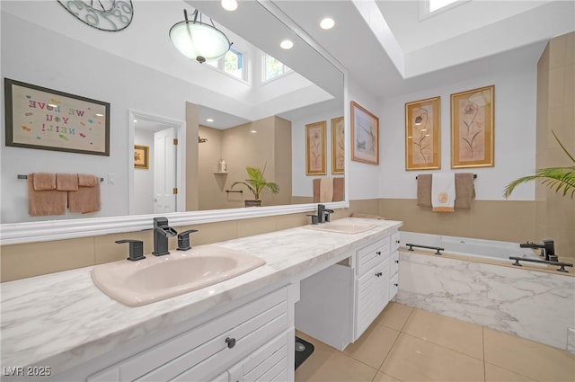 bathroom featuring double vanity, a sink, a bath, and tile patterned floors