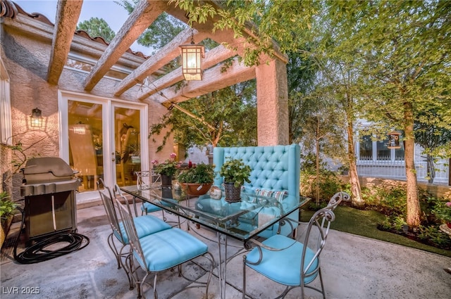 view of patio with outdoor dining area, fence, and french doors