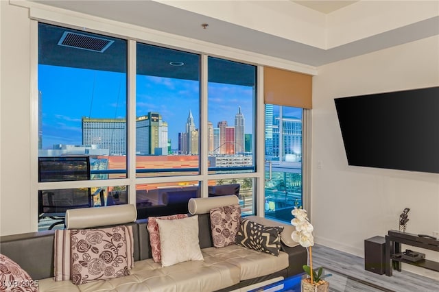 living room featuring visible vents and wood finished floors