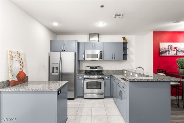 kitchen featuring gray cabinetry, a peninsula, visible vents, appliances with stainless steel finishes, and open shelves