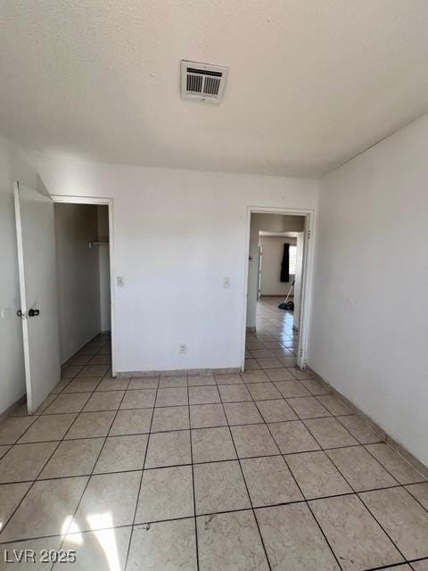 unfurnished room with light tile patterned floors and visible vents