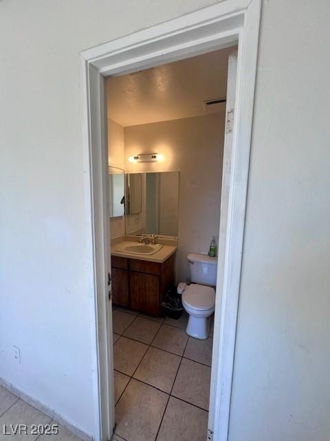 bathroom with visible vents, vanity, toilet, and tile patterned floors