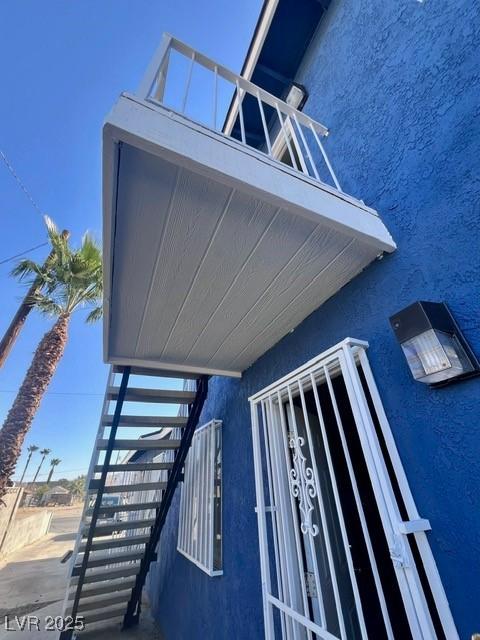 view of side of home with stucco siding