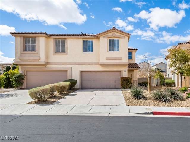 mediterranean / spanish-style house featuring an attached garage, a tiled roof, concrete driveway, and stucco siding