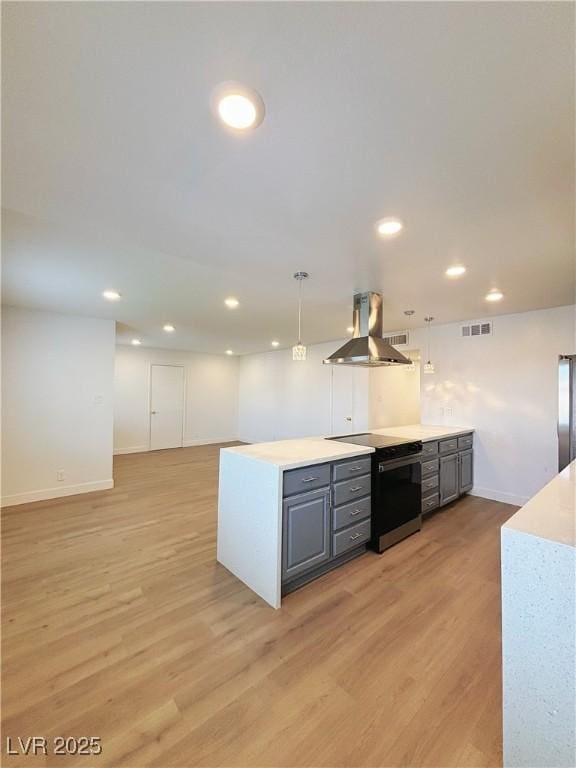 kitchen with gray cabinetry, island range hood, visible vents, electric stove, and light wood-type flooring