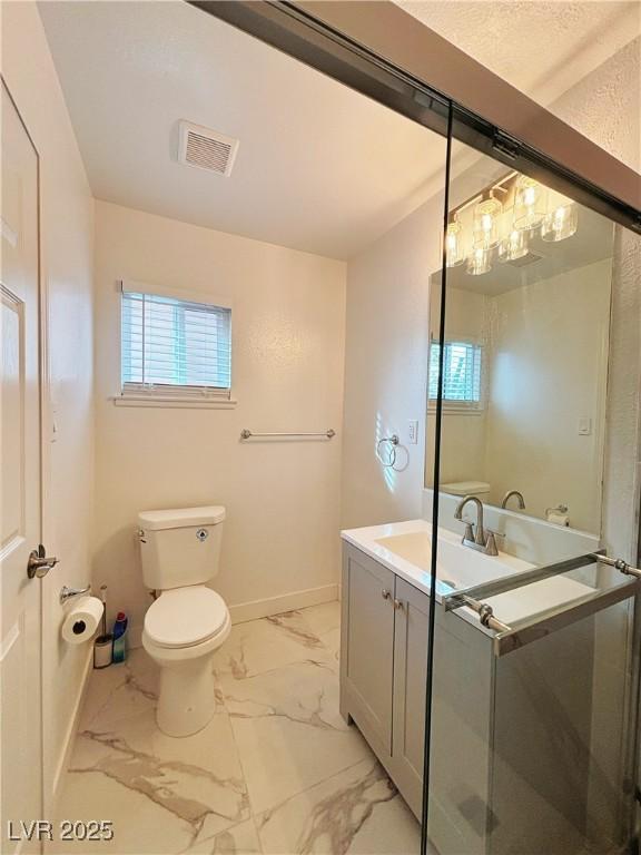 bathroom with marble finish floor, visible vents, toilet, vanity, and baseboards