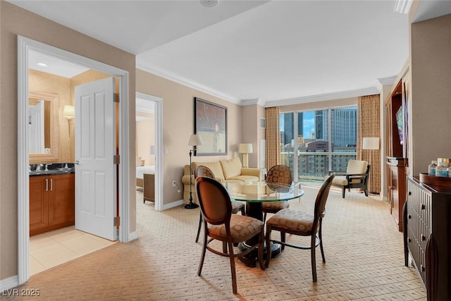 dining area featuring baseboards and crown molding