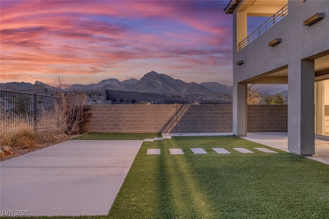 view of yard with a fenced backyard, a patio, and a mountain view