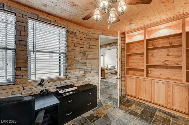 office space featuring ceiling fan, wood ceiling, and stone tile floors