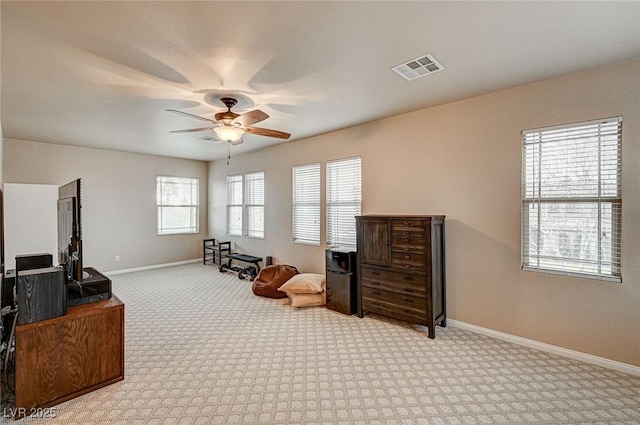 sitting room with a ceiling fan, baseboards, visible vents, and carpet flooring