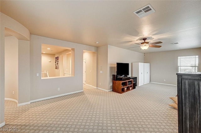 living area featuring ceiling fan, carpet, visible vents, and baseboards