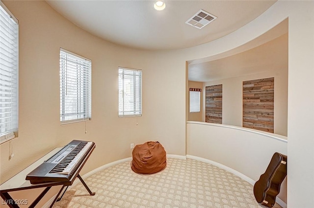 living area with baseboards, visible vents, and recessed lighting